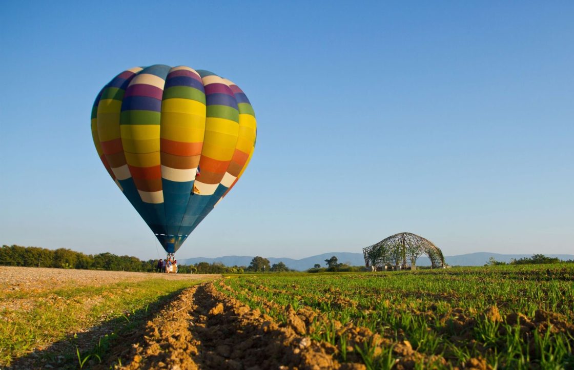 A multi-colored hot balloon on the ground