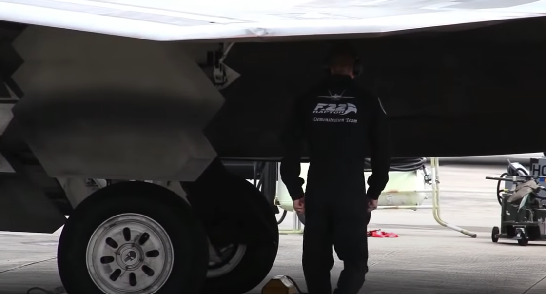 A close-up view of an F22 Raptor with a mechanic