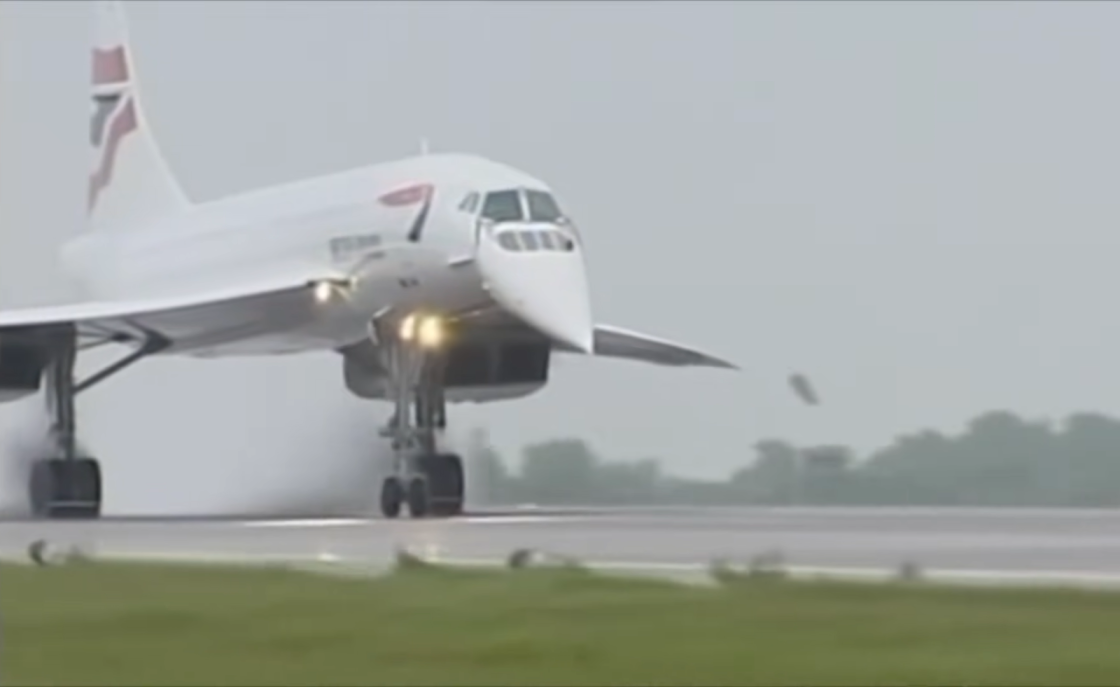 Concorde on the runaway, trees and grass near it