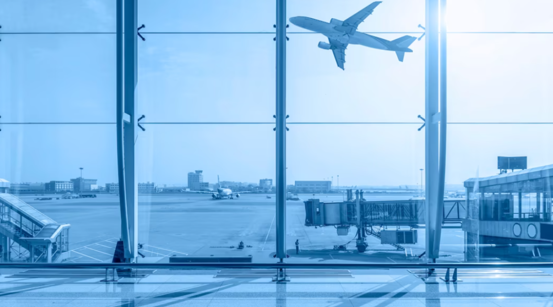 airport terminal and a plane taking off from the runway