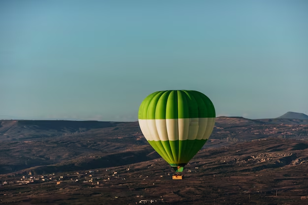 Hot air balloon above high mountain