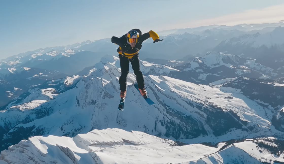 man on skiing in winter skydiving, snowy mountains