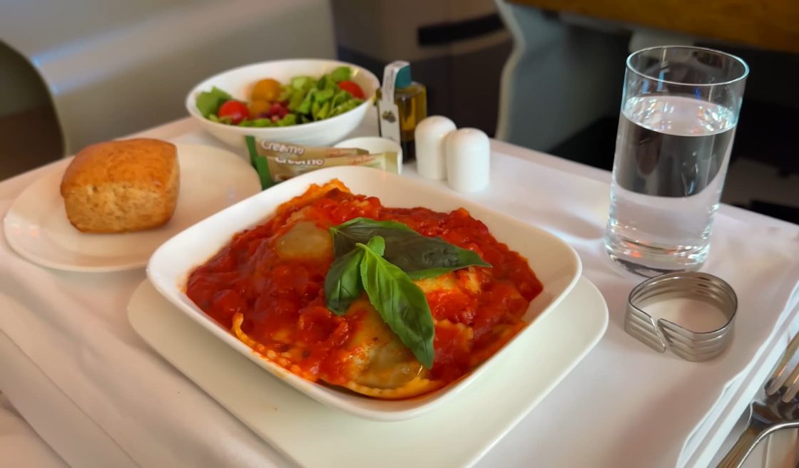 Airline meal of ravioli served with bread and salad