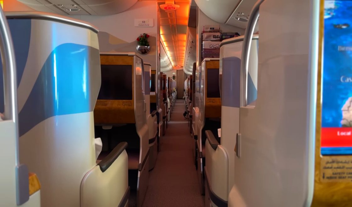 View down the aisle of an airplane's business class section